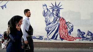 People walk past an anti-U.S. mural painted on the wall of the former U.S. Embassy in Tehran, Iran on August 19, 2023.