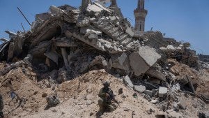 Israeli soldiers walk in the southern Gaza Strip