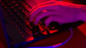 A close-up view of a hand typing on a computer keyboard