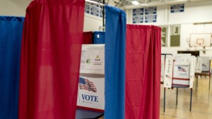 Voting booths are set up in a high school gymnasium