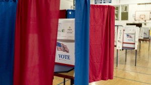 Voting booths are set up in a high school gymnasium