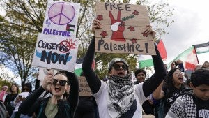 People hold signs calling for a ceasefire in Gaza