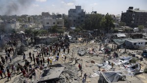 Palestinians inspect the damage at a site hit by an Israeli bombardment on Khan Younis, southern Gaza Strip