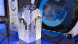 Glass Global Leadership Award on a table in front of the stage at the Global Leadership Awards Dinner. 