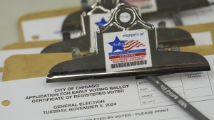 A close-up of a stack of clipboards shows a City of Chicago early voting application and a sticker reading "property of Chicago Board of Elections"