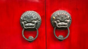 a red door with dragon handles