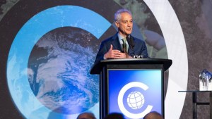 Rahm Emanuel speaks into a microphone onstage at the Global Leadership Awards Dinner.