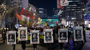 A group of protestors holding signs and flags against South Korean President Yoon Suk Yeol in Seoul, South Korea on December 5, 2024.