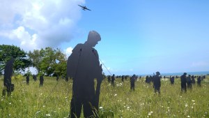 A plane flies past during a commemorative event for the 80th anniversary of D-Day