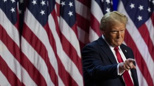 President Donald Trump points to the crowd at an election night watch party