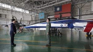 Taiwan's President Lai Ching-te listens to a briefing in an air hanger