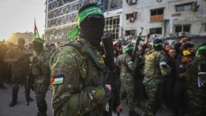 Hamas fighters control the crowd as Red Cross vehicles come to collect Israeli hostages 