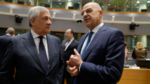 Greece's Foreign Minister Nikos Dendias (right) speaks with Italy's Foreign Minister Antonio Tajani during a EU foreign ministers meeting on May 22, 2023.