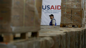 A man walks past boxes of USAID humanitarian aid at a warehouse at the Tienditas International Brigde in Columbia on February 21, 2019.