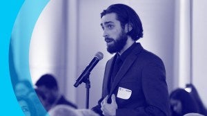 Event attendee speaking into microphone