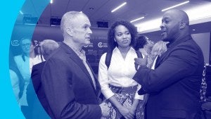 Three event attendees conversing.
