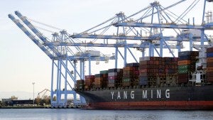 cargo cranes are used to take containers off of a Yang Ming Marine Transport Corporation boat at the Port of Tacoma