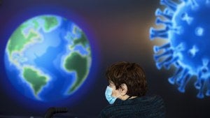 A woman wearing a face mask waits to receive a coronavirus vaccine