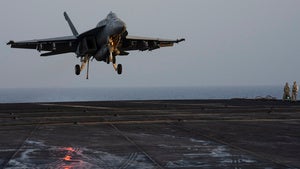 A fighter jet lands on the USS Dwight D. Eisenhower in the Red Sea