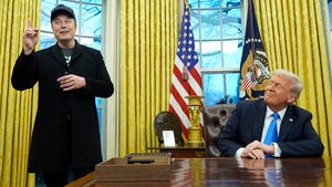 President Donald Trump listens as Elon Musk speaks in the Oval Office at the White House