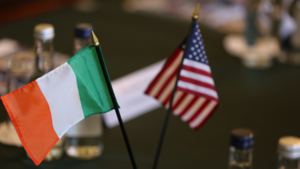 Miniature Irish and US flags sit on top of a table.