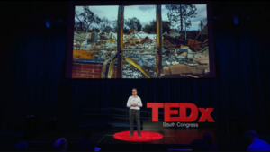 Joshua Busby presents on stage