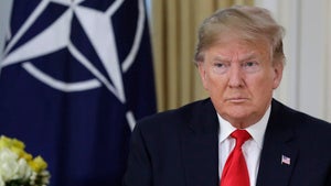 US President Donald Trump in front of a NATO flag