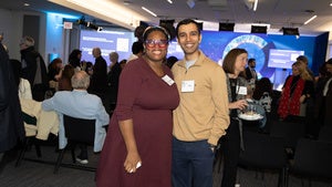 Two attendees smile for a photo at the Fulbright and Chicago Council 2025 Extravaganza. 