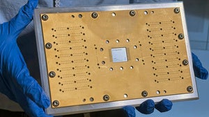 An IBM Heron quantum processor chip is in a circuit board at IBM headqauarters
