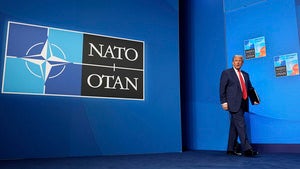 President Donald Trump arrives for a media conference at the end of the NATO summit