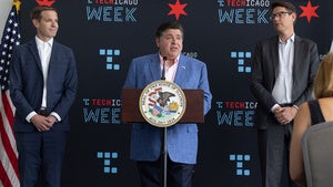 Governor Pritzker stands behind a podium