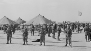 A black and white photo of U.N. troops guarding tents 