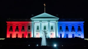 The White House is lit with the colors of the American flag