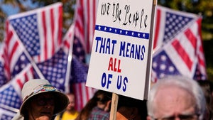 Protesters gather outside the U.S. Immigration and Customs Enforcement regional field office in Burlington, Mass