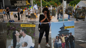 Ofir Kimchi prays as relatives and supporters of Israeli hostages held by Hamas celebrate news of a ceasefire deal at a plaza known as hostages square in Tel Aviv, Israel on October 9, 2025.