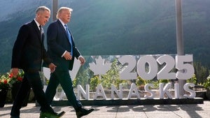 Canada's Prime Minister Mark Carney walks with President Donald Trump after a group photo at the G7 Summit, Monday, June 16, 2025, in Kananaskis, Canada.