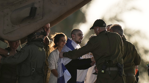 An Israeli hostage released from the Gaza Strip walks off a helicopter at the Sheba Medical Center in Ramat Gan, Israel.