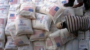 In this June 4, 2008 file photo, Palestinians unload bags of flour donated by the United States Agency for International Development
