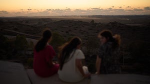 People observe buildings that were destroyed during the Israeli ground and air operations in the northern of Gaza Strip as they visit a sightseeing area in Sderot, southern Israel, Tuesday, Oct. 14, 2025. 