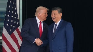 President Donald Trump and Chinese President Xi Jinping shake hands