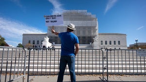 A demonstrator protests outside the Supreme Court