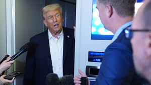 President Trump speaks to reporters on Air Force One while flying back to Washington on October 14, 2025.