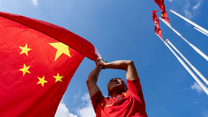 A man holds a Chinese national flag to mark the 76th National Day of the People's Republic of China in Hong Kong on October 1, 2025.