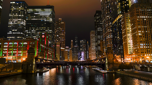 A photo of the Chicago river at night, looking east towards the skyline.
