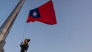 A guard adjusts a Taiwanese flag