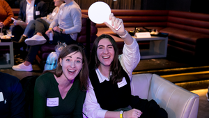 Two trivia bowl attendees smile for a photo.