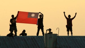 people hold a Taiwanese flag