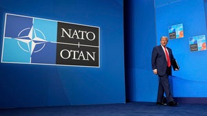 President Donald Trump arrives for a media conference at the end of the NATO summit