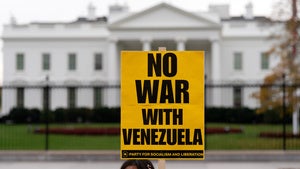 A demonstrator holds a sign while protesting outside of the White House in Washington