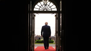 President Trump walks through a doorway 